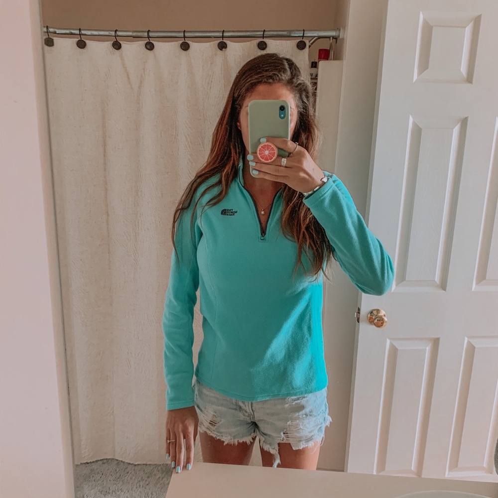 Woman’s teal North Face fleece pullover